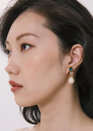 Luxury earrings with modern geometric design, featuring delicate crystal clusters and fluid drop pearl