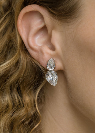 Close-up of model wearing Nadine Earrings – petite pear-shaped crystal studs adding subtle sparkle