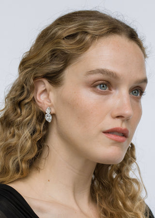 Model showcasing Nadine Earrings – elegant pear-shaped crystal studs perfectly complementing a casual hairstyle