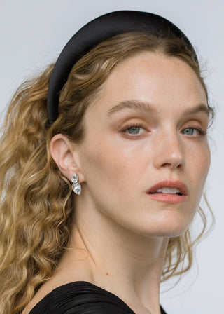 Model wearing Nadine Earrings – sparkling pear-shaped crystal studs framing the face