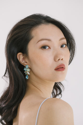 Handcrafted designer earrings featuring fine-cut crystals in a radiant, compact floral design