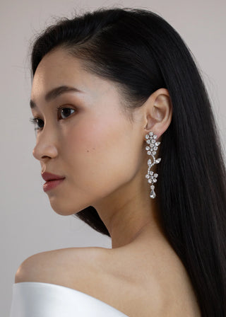 Model elegantly wearing Dania Earrings, highlighting their graceful movement and luxurious appeal.