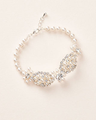 Pearl and crystal necklace on a light pink background