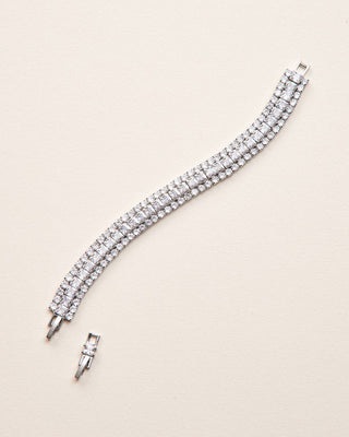 Silver bracelet with clear stones on a beige background