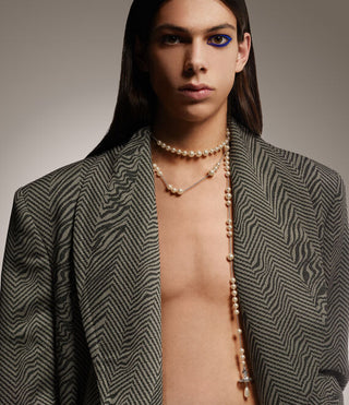 Male model wearing a silver-tone Broken Pearl necklace, styled with a casual outfit for a chic look.