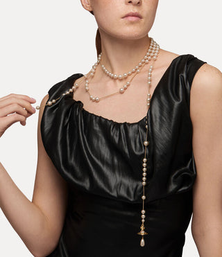 Close-up of a female model wearing a the Broken Pearl necklace with multi-colored Swarovski crystals.