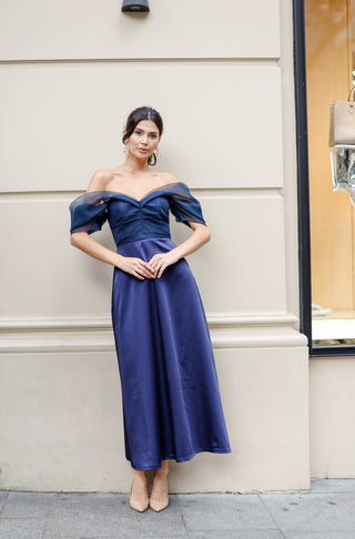 Sophisticated midi dress with an A-line crepe skirt, corseted bodice, and off-shoulder silk organza overlay for refined evenings