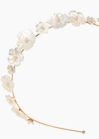 Close-up of the Jenna Headband featuring intricate hand-carved mother of pearl flowers on a gold-plated brass base against a white background.