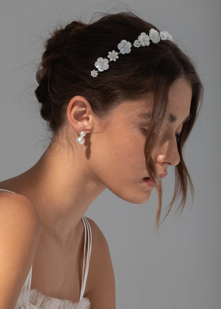 Model showcasing the Jenna Headband with mother of pearl flowers, styled elegantly in loose waves.