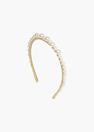 Flat lay of the Belladonna Headband on a neutral background, displaying its exquisite craftsmanship and the unique sizes of the Czech pearls that adorn it.