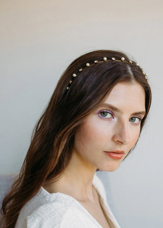 Side view of a model showcasing the Ines Skinny Headband, emphasizing how it seamlessly blends into the hair.