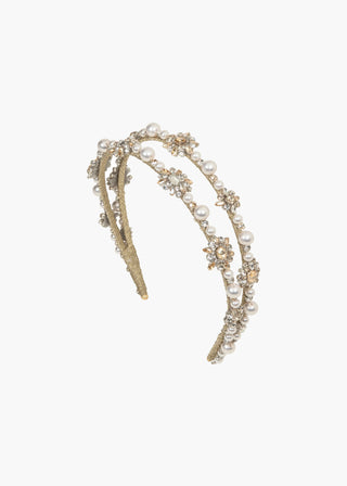 The Manon Headband displayed on a plain white background to emphasize its elegant design.