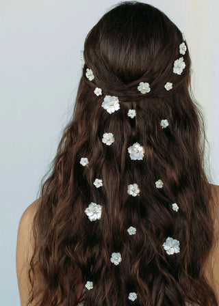 Artisan-crafted floral bobby pins with pearl details, adding a touch of luxury to any formal hairstyle.