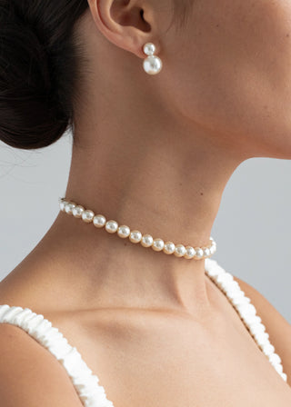 Model elegantly wearing the Pearl Ribbon Tie as a choker necklace, emphasizing the shimmering crystal pearls.