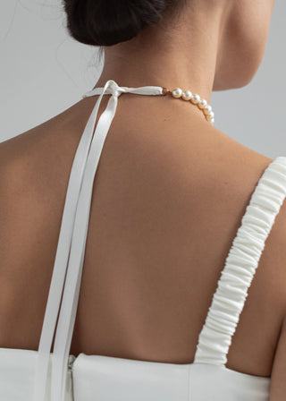 Back view of the Pearl Ribbon Tie on a model, highlighting the velvet ribbon tie and the delicate pearl detailing.