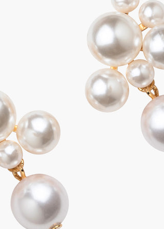 Close-up of Perlita Earrings on a white background, highlighting the modern pearl drop design and the intricate arrangement of pearls.