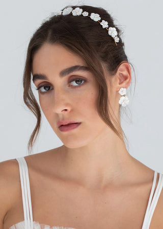 Model wearing the Tibby Earrings, with a soft-focus background emphasizing the earrings.