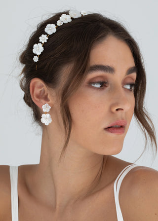 Model wearing the Tibby Earrings in an elegant setting, capturing the earrings' shine and movement.