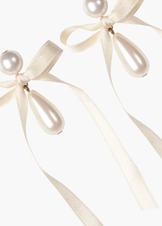 Evening-ready designer earrings featuring cascading pearl design and romantic handcrafted ribbon bow