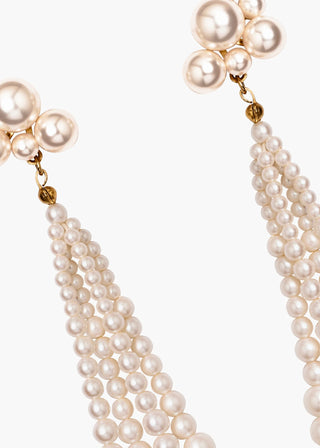 Couture-level earrings with fluid pearl tassels and bold stud silhouette, handcrafted for elevated occasions and red-carpet glamour.