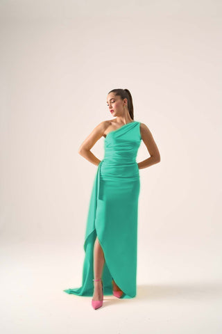 Sophisticated one-shoulder evening gown with a fitted bodice, high slit, and cascading side sash for a graceful, modern silhouette.