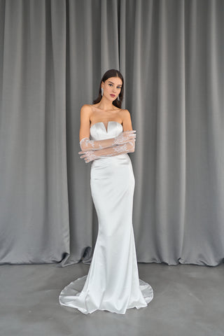 Timeless floor-length wedding dress with a minimalist design and sculpted fit