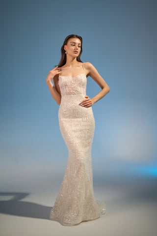 Sophisticated wedding dress with spaghetti straps, a subtly curved neckline, and an elegant mermaid silhouette with intricate beading.