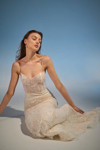 Scoop neckline bridal gown in a mermaid style with intricate beadwork and delicate spaghetti straps, perfect for a statement wedding.