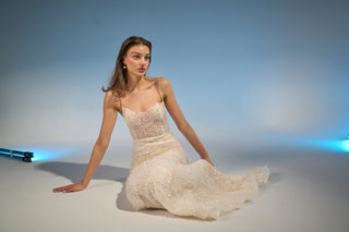 Bridal gown with a timeless mermaid silhouette, scoop neckline, and elegant beaded details, perfect for a luxury wedding.