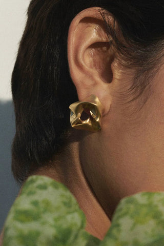 Hand-formed scrunch earrings with an organic silhouette, inspired by the elegance of flowing fabric.