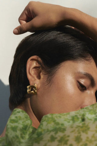 Artistic earrings with a fluid, gathered form, embodying Completedworks’ signature sculptural craftsmanship.