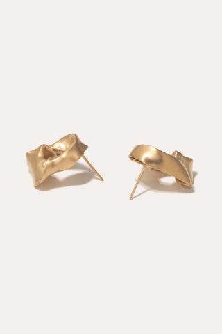 Luxury statement earrings featuring intricate folds and sculptural detailing, evoking Renaissance drapery.