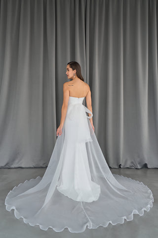 Luxurious organza overskirt with a cascading A-line silhouette, adding movement and drama to evening ensembles.