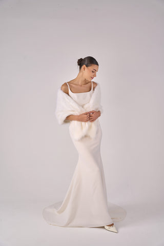 Woman wearing a white wedding dress with a plain background