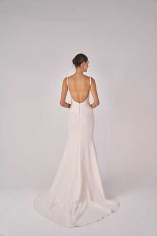 White wedding dress with open back on a white background