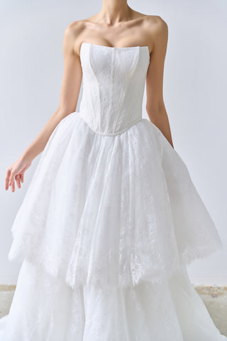 White strapless wedding dress on a plain background