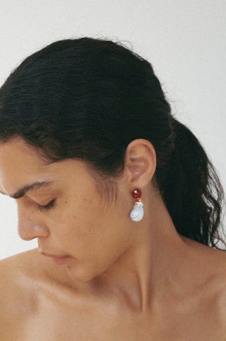 Sculptural earrings with contemporary design, featuring bold resin and agate accents in recycled silver.