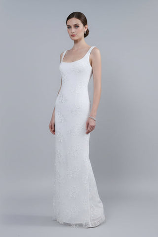 Woman wearing a white lace dress on a gray background