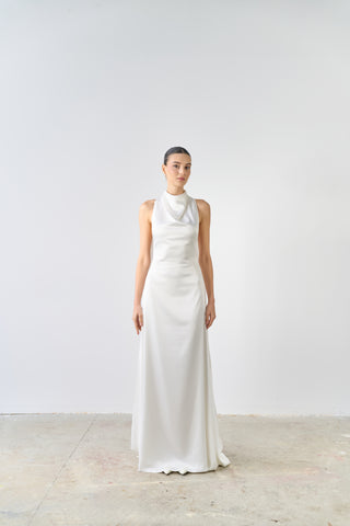 Woman wearing a white dress against a plain background