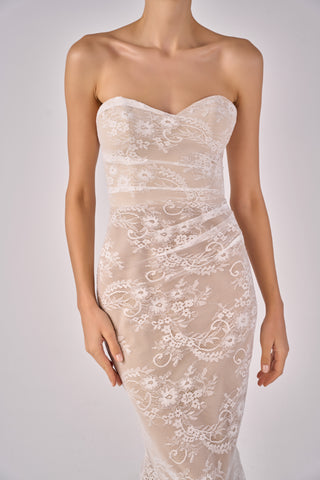 White lace strapless gown on a mannequin against a plain background