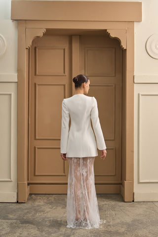 Unique wedding dress with a fashion-forward blazer bodice, long sleeves, and sheer lace skirt, blending structure and romance.