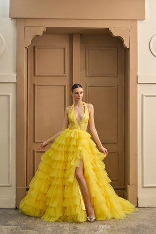 Statement evening dress featuring a structured bodice with intricate embellishments and a voluminous layered tulle skirt.