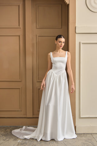 Designer wedding dress with a structured square neckline and flattering A-line skirt, perfect for a romantic, modern bride.