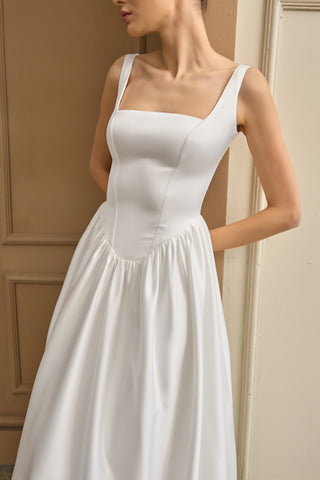 Bridal gown with a sleek square neckline, sleeveless design, and flowing silhouette, crafted for effortless sophistication.