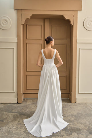 A-line wedding dress featuring a corset-fitted bodice and delicate draping, creating a luxurious, ethereal bridal look.