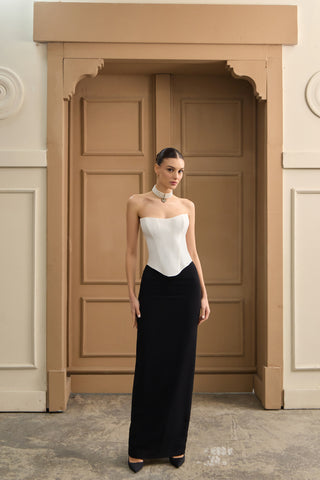 Regal corset bridal gown with a structured bodice, sculpted neckline, and flowing skirt for an opulent wedding look.