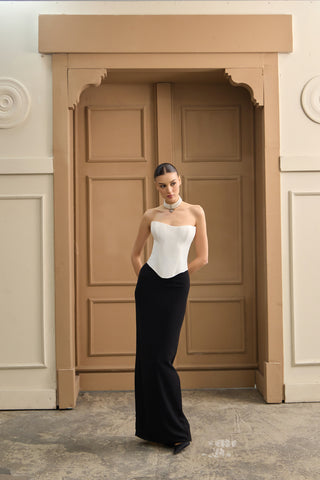 Elegant wedding dress featuring a corset-style bodice, sleek column silhouette, and a billowing skirt for graceful movement.