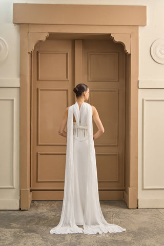 Designer wedding dress featuring a corset-style top, sweetheart neckline, and flowing column skirt for timeless elegance.