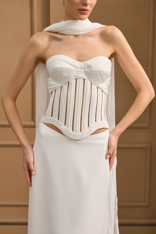 Modern column wedding gown featuring a strapless corset bodice with intricate boning and a flowing, ethereal skirt.