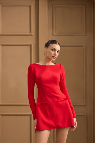 Chic mini sheath dress with a refined round neckline, sleek long sleeves, and delicate bow accents for an elegant evening look.